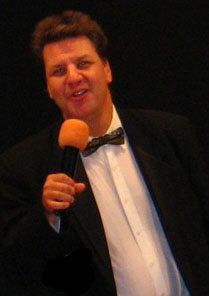 Troy Harris singing in a tuxedo